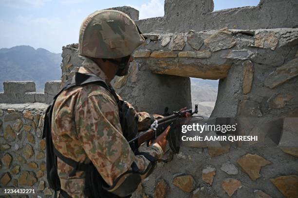 Pakistani army soldier mans a position at the Pakistan-Afghanistan border near Big Ben post in Khyber district in Khyber Pakhtunkhwa province August...