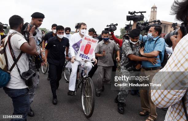Congress leader Rahul Gandhi rides a bicycle in a symbolic protest over rising fuel prices near Parliament House on August 3, 2021 in New Delhi,...