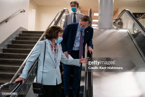 Sen. Dianne Feinstein speaks with Sen. John Hickenlooper as they make their way through the Senate Subway on Capitol Hill on Tuesday, Aug. 3, 2021 in...