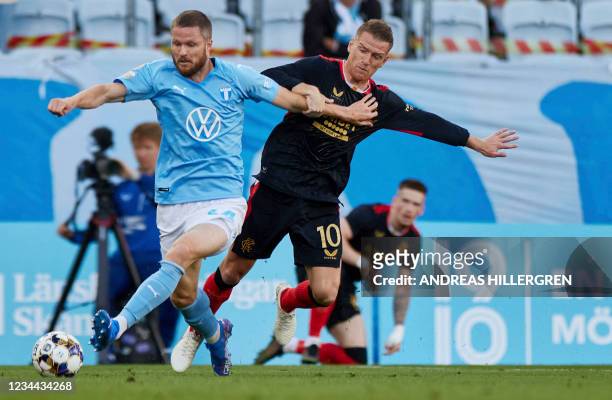 Malmo FF's Danish defender Lasse Nielsen and Rangers' Northern Irish midfielder Steven Davis vie for the ball during the Champions League qualiying...