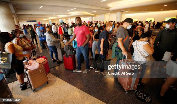 Passengers form a line inside LAX Terminal 5 Tuesday morning as Spirit Airlines has canceled 313 flights on Monday, 40% of its scheduled flights, and...