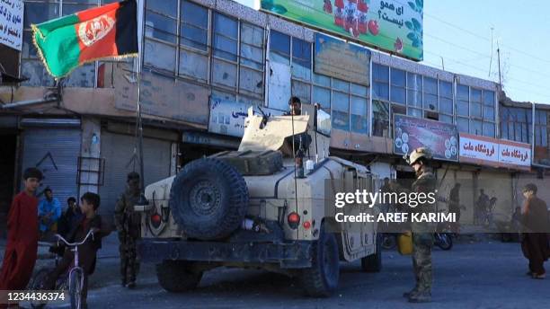 This video screen grab from AFPTV shows Afghan special forces patrol the streets of Herat as the Taliban continue a series of offensives against...