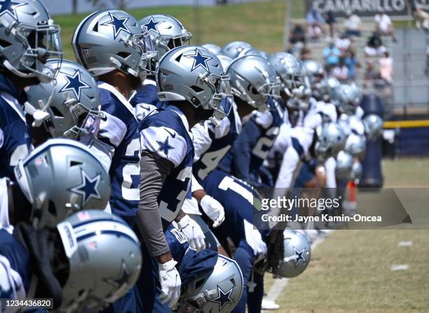 The Dallas Cowboys warm up during training camp at River Ridge Complex on August 3, 2021 in Oxnard, California.