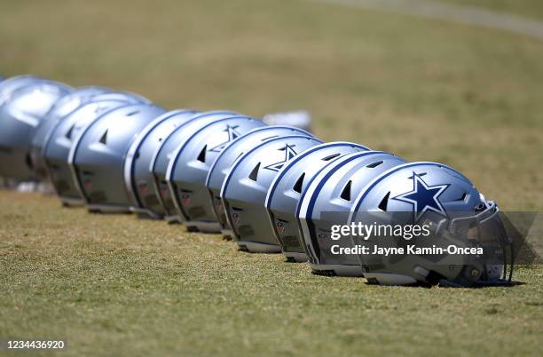 Detailed view of helmets of the Dallas Cowboys lined up on the field during training camp at River Ridge Complex on August 3, 2021 in Oxnard,...