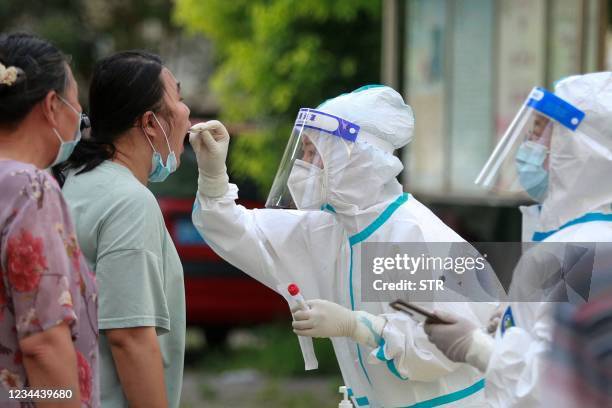 This photo taken on August 3, 2021 shows a resident receiving nucleic acid tests for the Covid-19 coronavirus in Yangzhou in China's eastern Jiangsu...