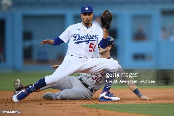 Kyle Tucker of the Houston Astros slides into second base and beats the throw to Mookie Betts of the Los Angeles Dodgers for a double in the second...