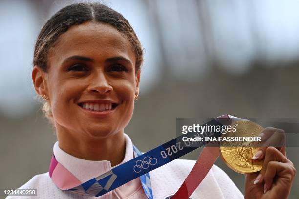 Gold medallist USA's Sydney Mclaughlin poses with her medal on the podium after the women's 400m hurdles event during the Tokyo 2020 Olympic Games at...