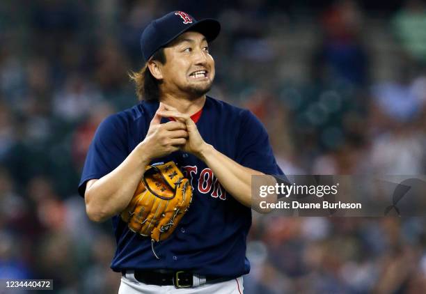 Pitcher Hirokazu Sawamura of the Boston Red Sox reacts after walking Robbie Grossman of the Detroit Tigers during the fifth inning at Comerica Park...