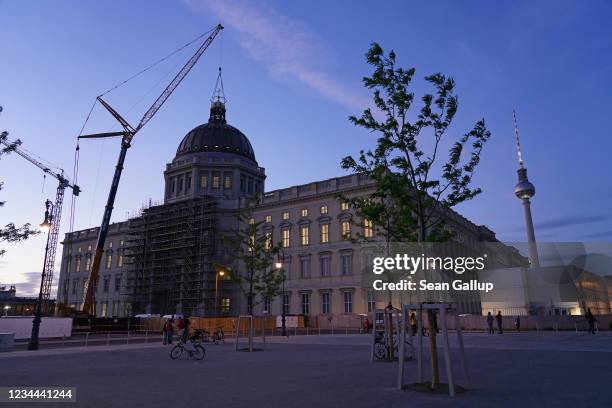 The rebuilt Berlin City Palace stands complete with its newly-finished gold-covered cupola and cross after a crane lifted the piece onto the palace...