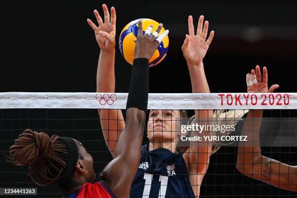 Dominican Republic's Brayelin Martinez hits the ball in front of USA's Andrea Drews in the women's quarter-final volleyball match between USA and...