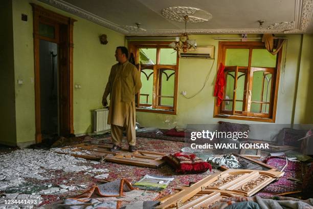 Graphic content / An Afghan security personnel inspects the damages inside a building a day after a car bomb explosion in Kabul on August 4, 2021. /...