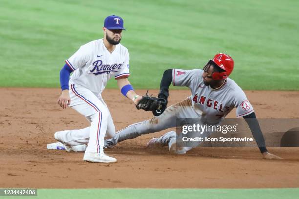 Los Angeles Angels center fielder Jo Adell slides into second base as Texas Rangers third baseman Isiah Kiner-Falefa fields the baseball during the...