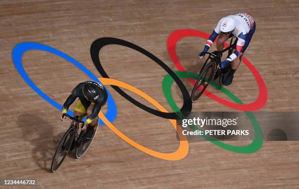 Britain's Jason Kenny and Malaysia's Mohd Azizulhasni Awang compete in a heat of the men's track cycling sprint 1/32 finals during the Tokyo 2020...