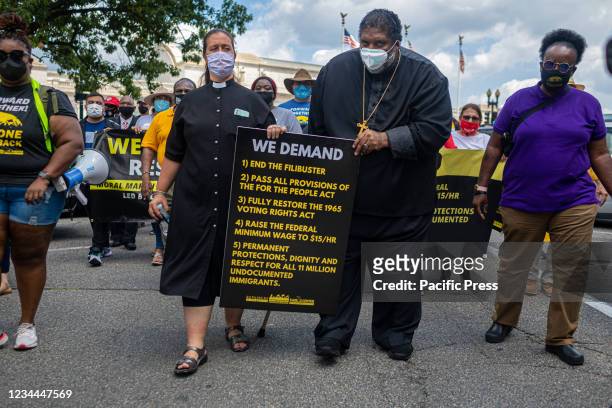 Reverend Doctor Liz Theoharris and Reverend Doctor William Barber lead the march toward the Capitol building. The Poor People's Campaign rallied and...