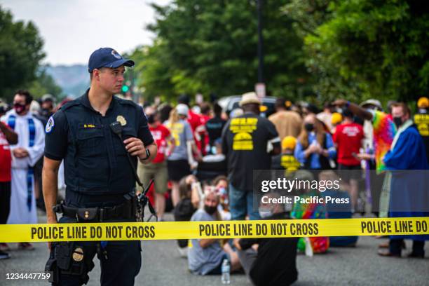 Capitol Police guard the arrestees. The Poor People's Campaign rallied and marched in Washington DC, where faith leaders, low-wage workers, and poor...