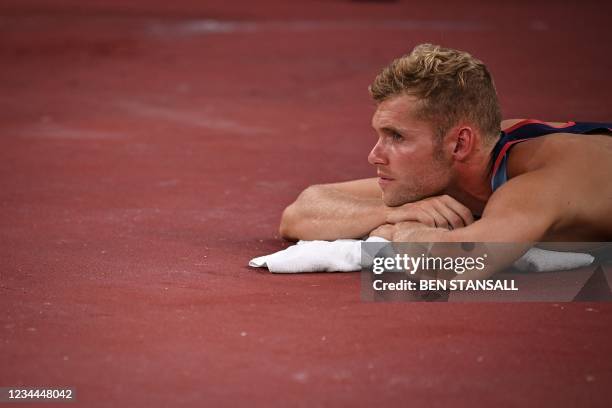 France's Kevin Mayer relaxes on the side ahead of his attempt in the men's decathlon high jump during the Tokyo 2020 Olympic Games at the Olympic...