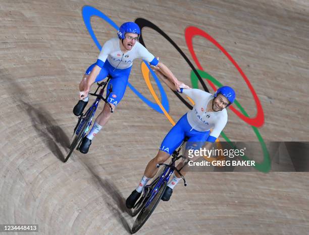 Italy's Simone Consonni and Italy's Filippo Ganna celebrate after winning gold and setting a new World Record in the men's track cycling team pursuit...