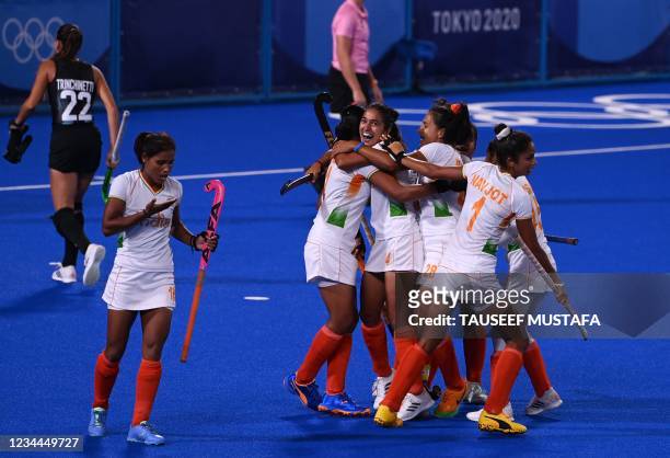 India's Gurjit Kaur embraces with teammates after scoring against Argentina during their women's semi-final match of the Tokyo 2020 Olympic Games...