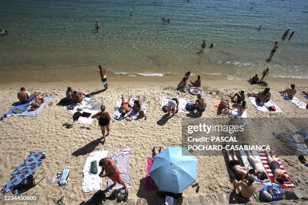 People enjoy the Saint Francois beach in Ajaccio on August 3 as health officials activated an emergency plan on the Mediterranean island of Corsica...