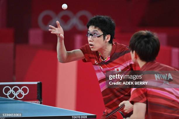 Japan's Jun Mizutani and Japan's Koki Niwa compete during their men's team semifinal table tennis match against Germany at the Tokyo Metropolitan...