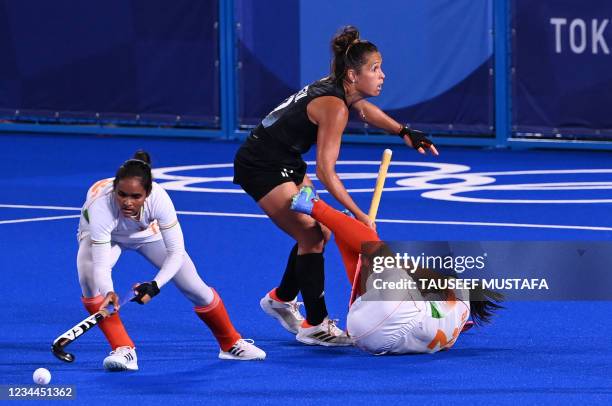 India's Sushila Chanu Pukhrambam falls next to Argentina's Rocio Sanchez Moccia as India's Sushila Chanu Pukhrambam goes for the ball during their...