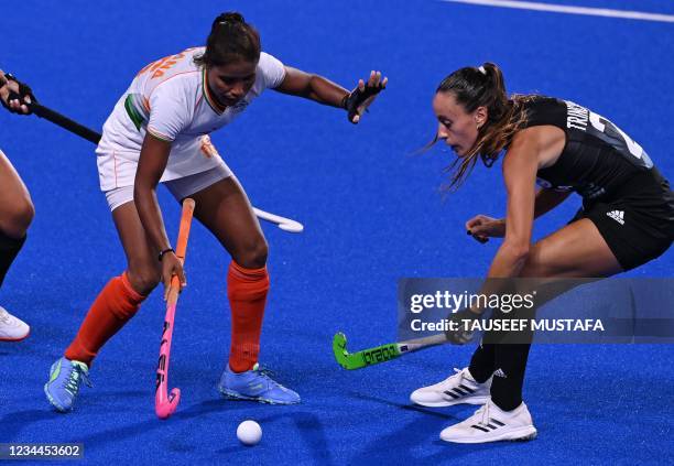 India's Vandana Katariya and Argentina's Eugenia Maria Trinchinetti vie for the ball during their women's semi-final match of the Tokyo 2020 Olympic...