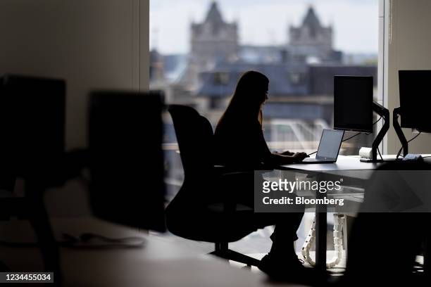 An office worker at a desk in view of Tower Bridge in the offices of Arcadis NV, after increasing their workplace capacity on July 19, in London,...