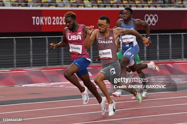 First-placed Canada's Andre De Grasse crosses the finish line to win followed by Second-placed USA's Kenneth Bednarek in the men's 200m final during...