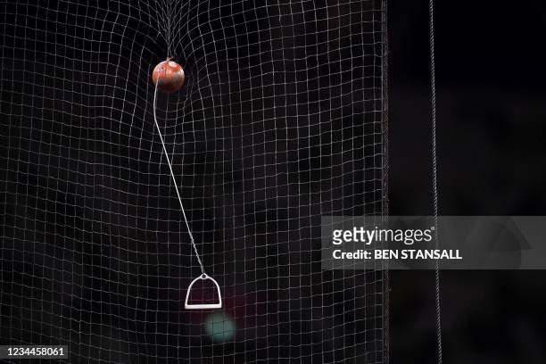 Hammer hangs on the net of the cage after getting stucked following a throw by USA's Daniel Haugh during the men's hammer throw final during the...
