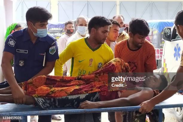 Graphic content / Police and relatives transport the body of a victim who died in a lightning strike in Chapai Nawabganj district, about 300 km from...