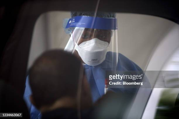 Healthcare worker collects a Covid-19 swab test at a drive-thru testing site outside the Southwest Multi-Service Center in Houston, Texas, U.S., on...