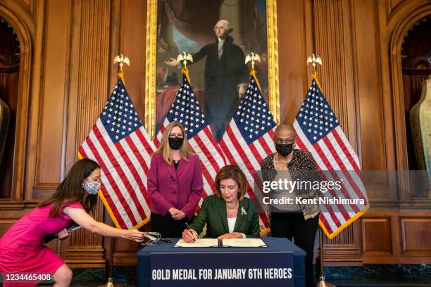 Speaker of the House Nancy Pelosi flanked by with Rep. Jennifer Wexton , left, and Del. Eleanor Holmes Norton , right, signs H.R. 3325, in the...
