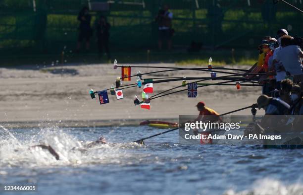 Swimmers approach the feeding station during the Men's 10km Marathon Swimming race at Odaiba Marine Park on the thirteenth day of the Tokyo 2020...