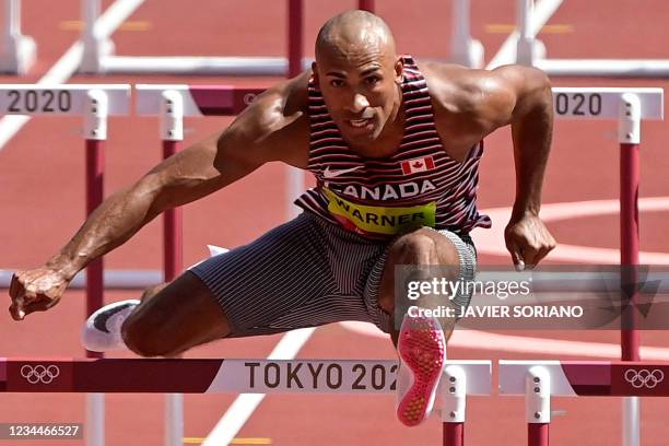 Canada's Damian Warner competes in the men's decathlon 110m hurdles during the Tokyo 2020 Olympic Games at the Olympic Stadium in Tokyo on August 5,...