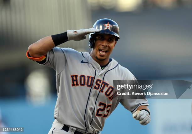 Michael Brantley of the Houston Astros celebrates after hitting a solo home run against pitcher Max Scherzer of the Los Angeles in the first inning...