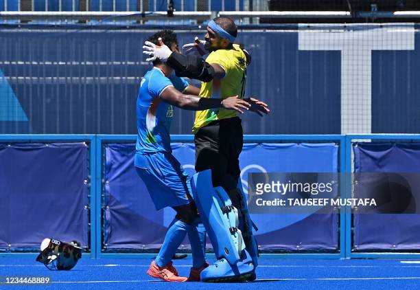 India's goalkeeper Sreejesh Parattu Raveendran and a teammate celebrate after winning the men's bronze medal match of the Tokyo 2020 Olympic Games...