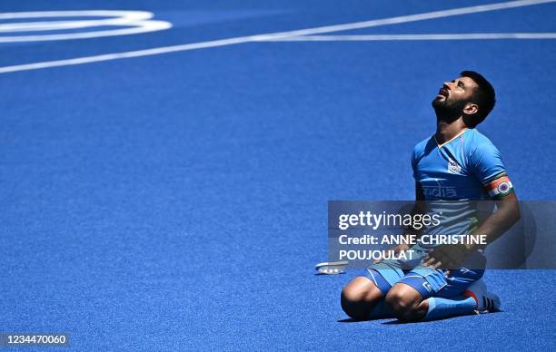 India's Manpreet Singh reacts after winning the men's bronze medal match of the Tokyo 2020 Olympic Games field hockey competition by defeating...