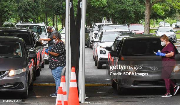 Cars line up at a drive-thru COVID-19 testing site at Econ Soccer Complex in Orlando. The Florida Hospital Association reported 16,935 newly detected...