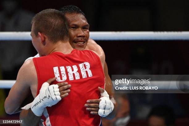 Ukraine's Oleksandr Khyzhniak and Philippines' Eumir Marcial hug after their men's middle semi-final boxing match during the Tokyo 2020 Olympic Games...