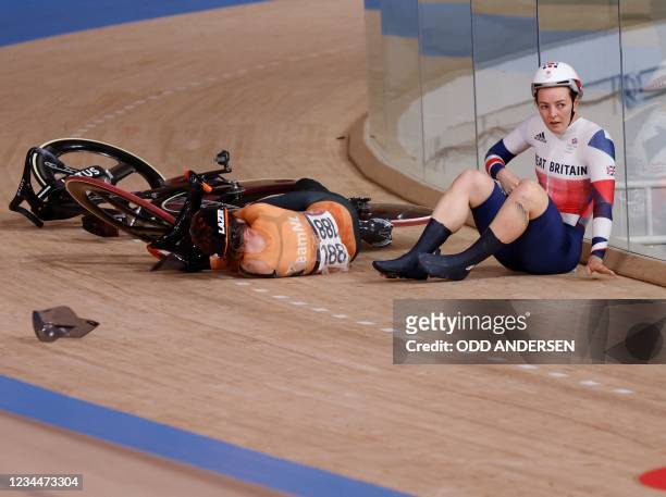 Netherlands' Laurine van Riessen lies on the track next to Britain's Katy Marchant after they crashed during a heat of the women's track cycling...