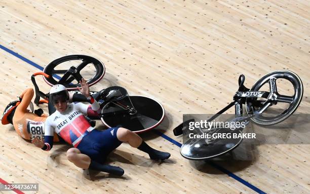 Britain's Katy Marchant and Netherlands' Laurine van Riessen crash during a heat of the women's track cycling keirin quarter-finals during the Tokyo...