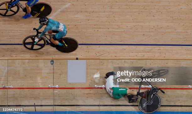 Mexico's Luz Daniela Gaxiola Gonzalez crashes during a heat of the women's track cycling keirin semi-finals during the Tokyo 2020 Olympic Games at...