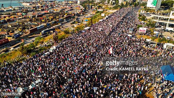 This picture taken on August 4, 2021 shows an aerial view of demonstrators gathered outside the port of Lebanon's capital Beirut on the first...