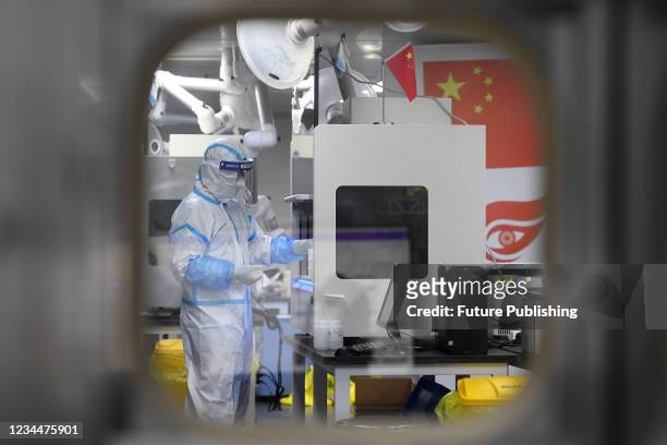 People in PPE work in the Huo-Yan Laboratory designed for high-capacity 2019-nCoV detection in Wuhan in central China&#039;s Hubei province Thursday,...