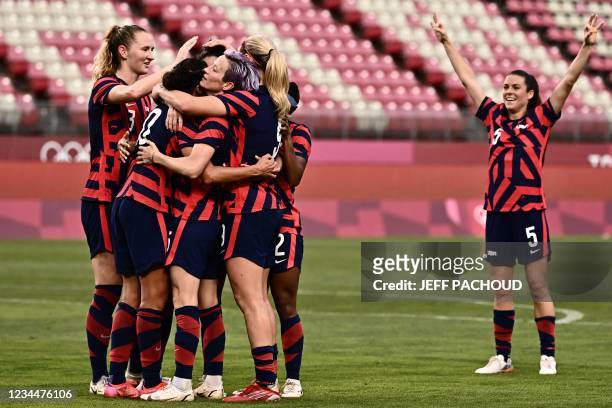 S forward Carli Lloyd is congratulated by teammates after scoring during the Tokyo 2020 Olympic Games women's bronze medal football match between...