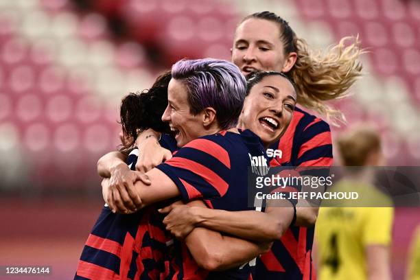 S forward Carli Lloyd is congratulated by teammates after scoring during the Tokyo 2020 Olympic Games women's bronze medal football match between...