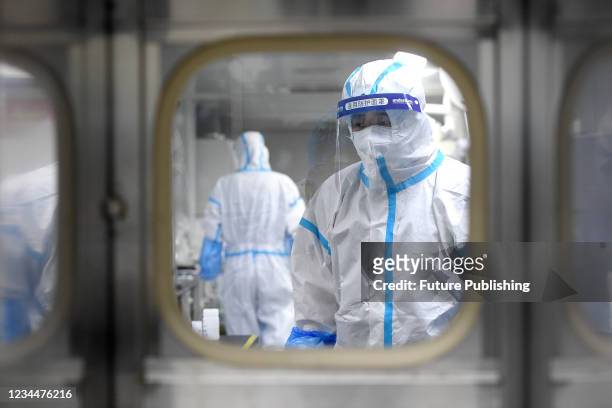 People in PPE work in the Huo-Yan Laboratory designed for high-capacity 2019-nCoV detection in Wuhan in central China&#039;s Hubei province Thursday,...