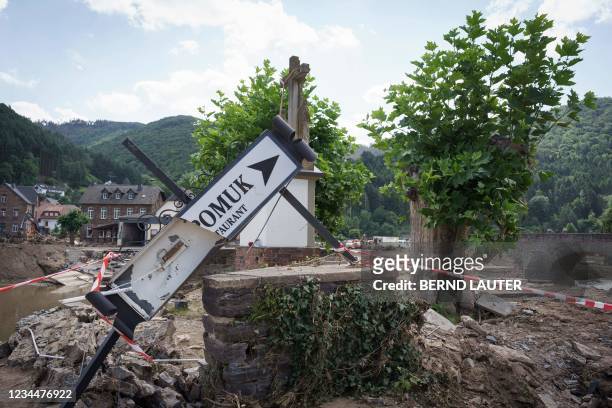 Damaged sign pointing to a restaurant is seen among debris in the wine village of Rech near Dernau, North Rhine-Westphalia, western Germany, on July...