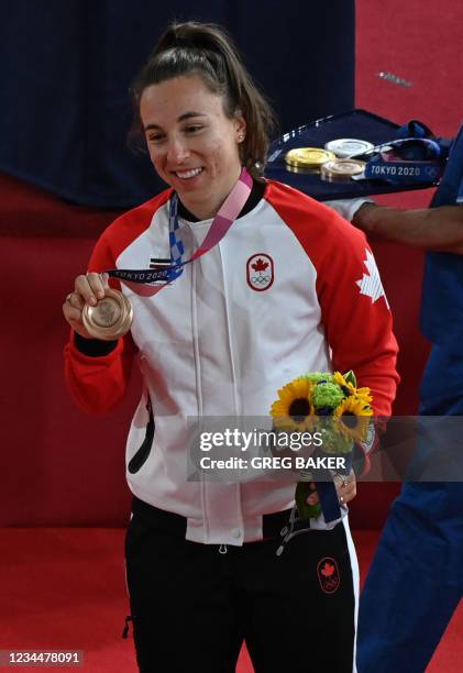 Bronze medallist Canada's Lauriane Genest poses with her medal after the women's track cycling keirin final during the Tokyo 2020 Olympic Games at...