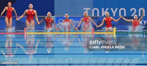 Spain's goalkeeper Laura Ester Ramos and her teammates jump in to the water ahead of the Tokyo 2020 Olympic Games women's water polo semi-final match...